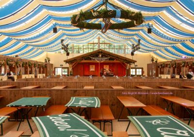 a large tent boandlkramerei Oktoberfest Munich with tables and chairs